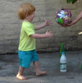 Toddler steps forward to take ball 2.jpg
