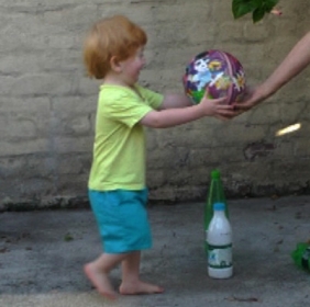 Toddler steps forward to take ball 3.jpg